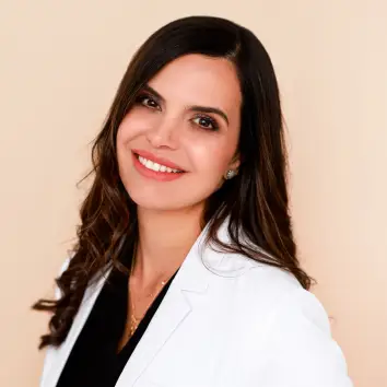Portrait of an Advanced Aesthetics team member in a white coat.