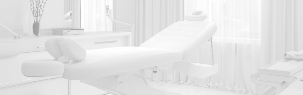 Treatment room with a reclining chair and medical equipment.